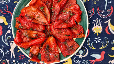 Poivrons rouges grillés au charbon de bois, coupés en lanières et assaisonnés d'huile d'olive, d'ail et de persil plat.